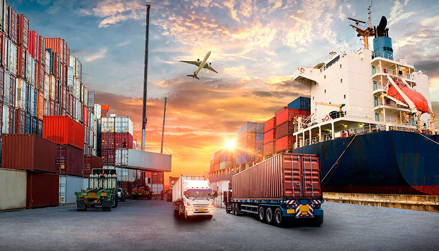 A cargo port scene at sunset with stacked shipping containers, a large ship, trucks, a forklift, and an airplane flying through the sky.
